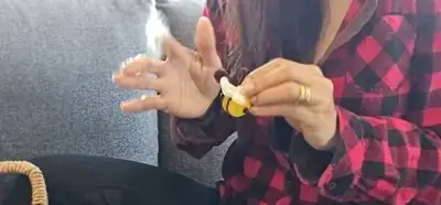 Skilled hands crafting white wings for handmade pipe cleaner bee